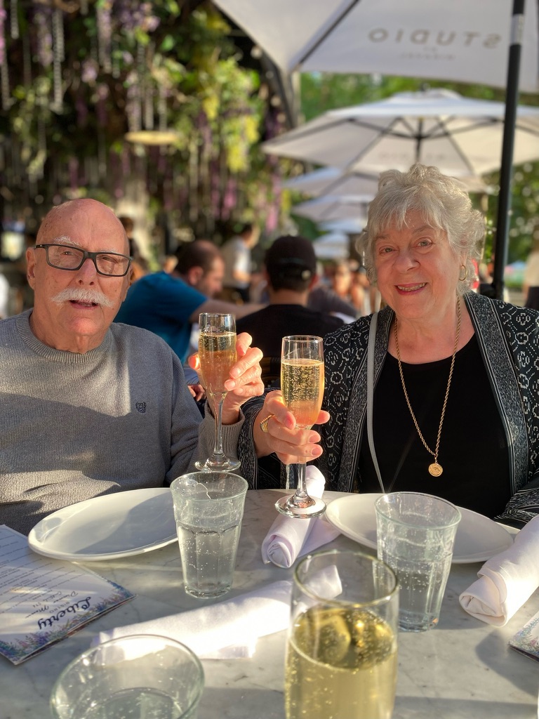 Marshall and his wife raising glasses together