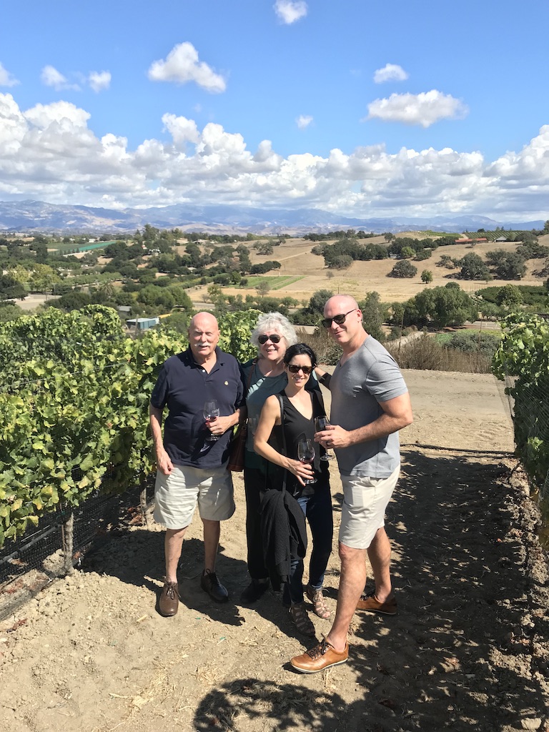 Marshall and Marian traveling with family in a vineyard