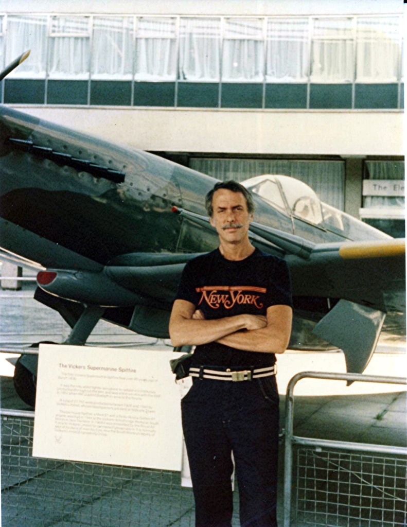 Marshall standing proudly beside a historic airplane