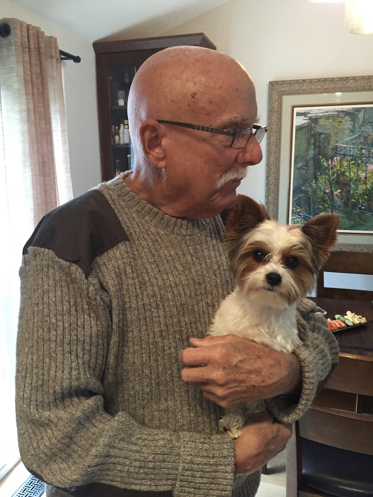 Marshall holding a small family dog