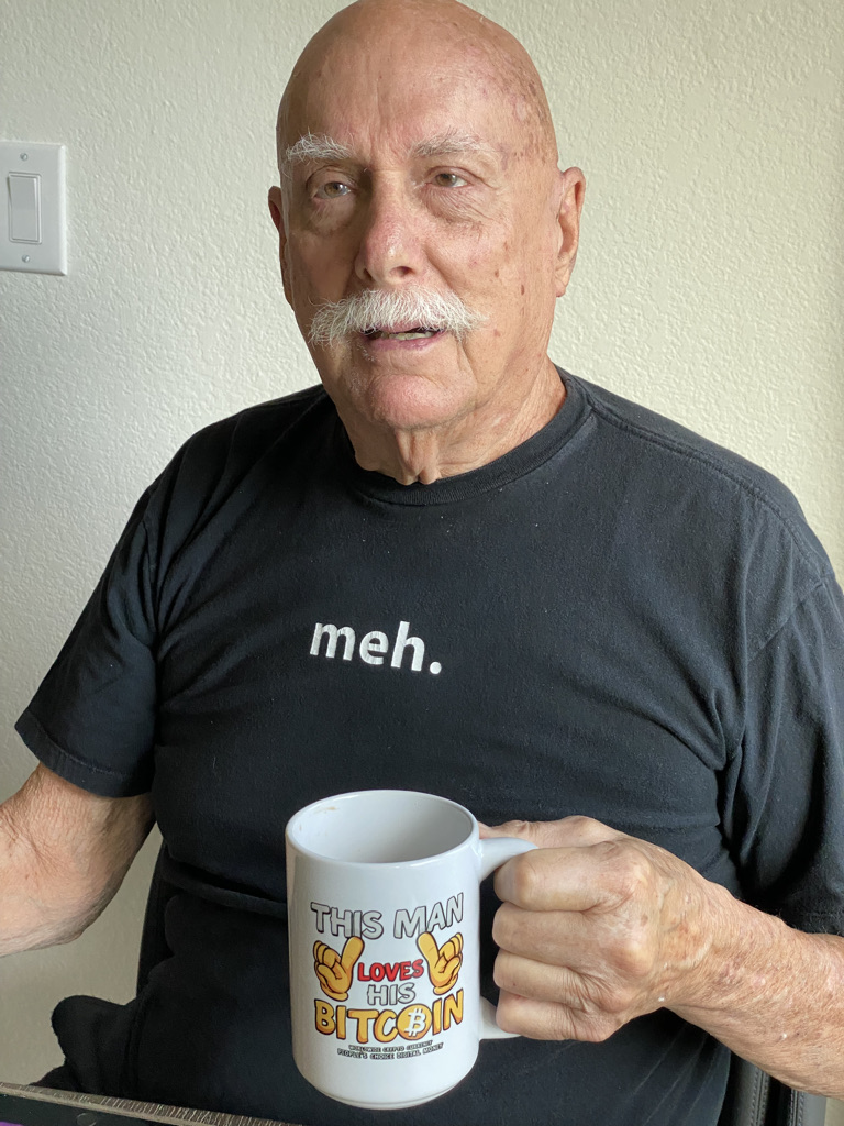 Marshall enjoying a cup of coffee in his perfectly understated “meh” shirt
